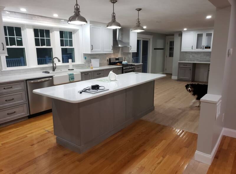 Completed kitchen remodel with modern cabinetry, updated lighting, and clean finishes.