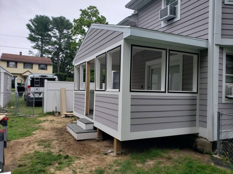 Finished home addition showing seamless integration with the original structure and updated siding.