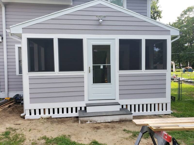 Exterior view of the completed addition with clean trim work and new windows.