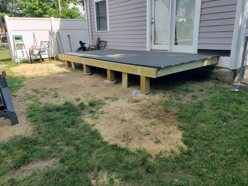 Home addition nearing completion with exterior details and structural work visible.