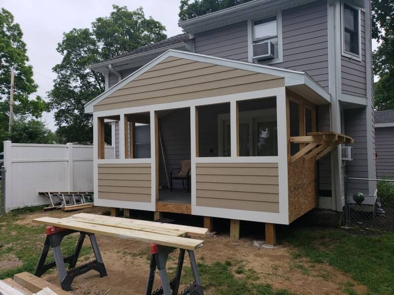 Addition under construction with exterior sheathing installed and framing completed.
