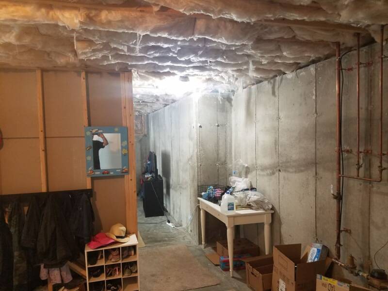 Basement build in progress with drywall installation and unfinished surfaces.