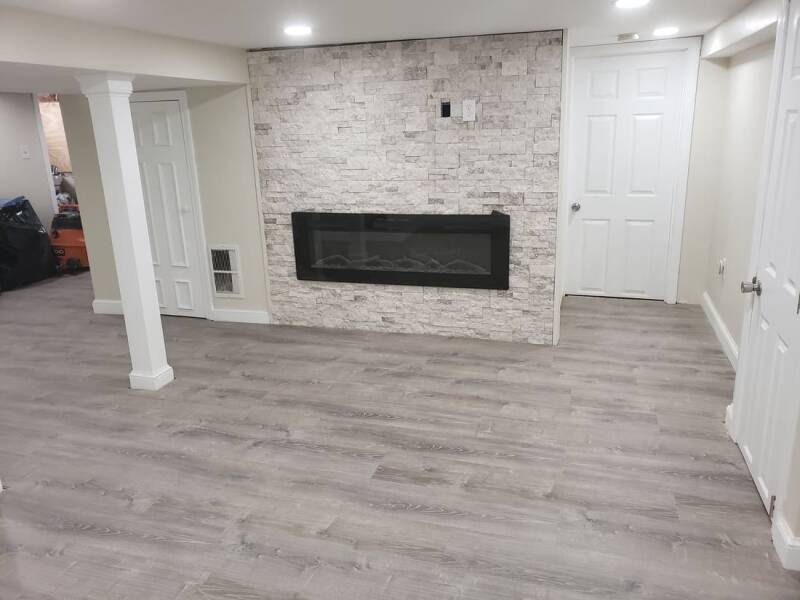 Finished basement with updated walls, modern lighting, and a clean open layout.