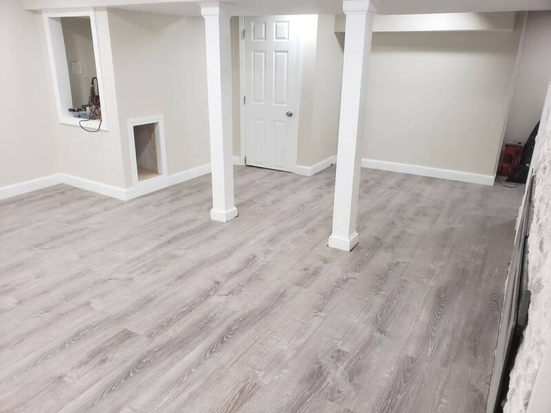 Finished basement with new flooring, recessed lighting, and clean modern finishes.