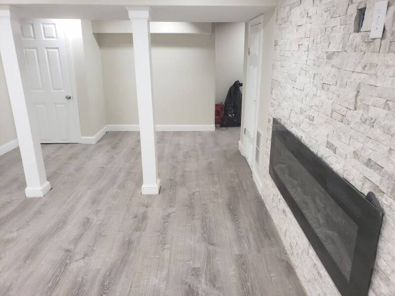 Renovated basement showing updated walls, bright lighting, and an open layout.