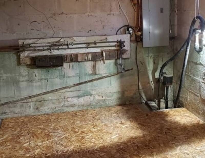 Basement renovation showing flooring preparation and ongoing interior work.