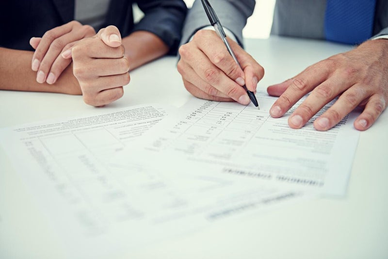 Two people filling a form