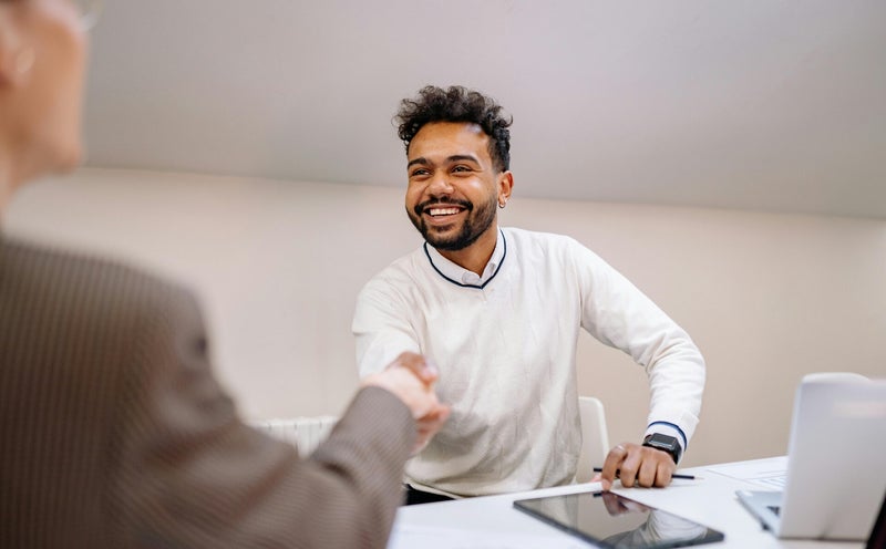 Young man shaking hands with the interview during a job interview