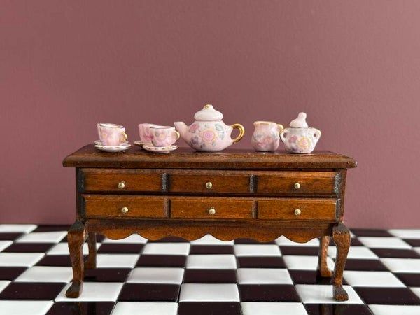 Houten kast met elegante poten en messingkleurige knopjes