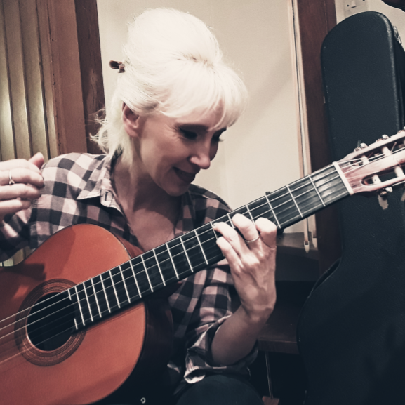 Emma Goss playing classical guitar