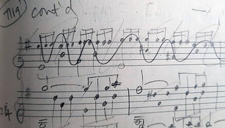 Handwritten music notation with bars crossed out