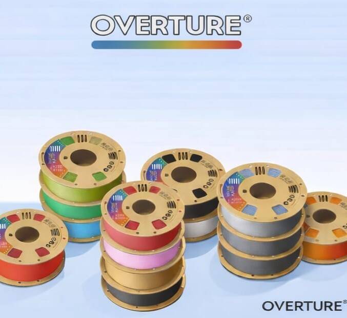 Assortment of Overture 3D printer filament spools in various colors, neatly arranged. High-quality PLA filament made in the USA, trusted by 3D Creations workshop in Bangor PA for consistent printing results.