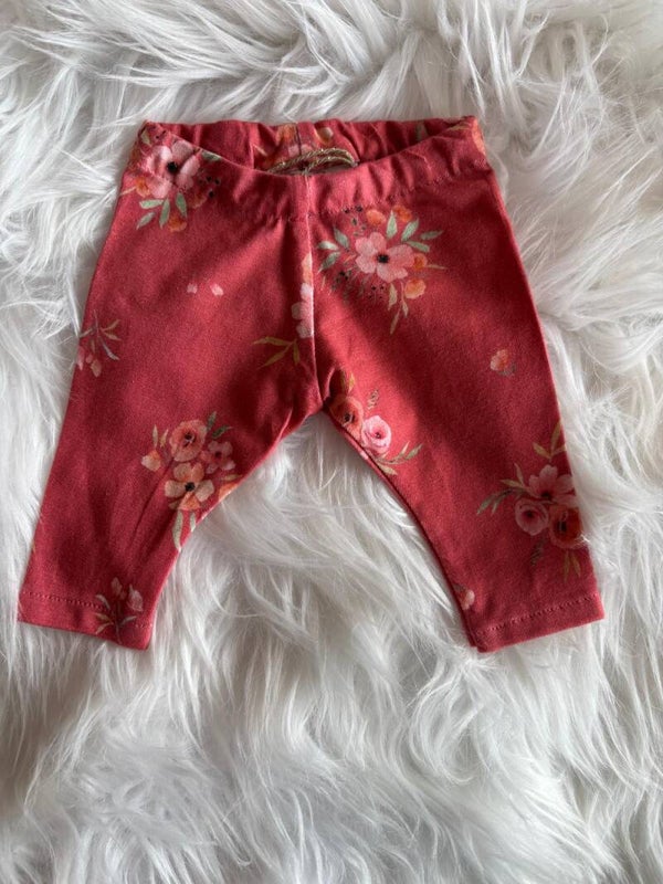 Broekje rood met roze bloemen.