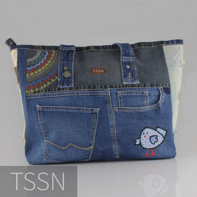 Denim herinneringstas met geappliceerd vogeltje.