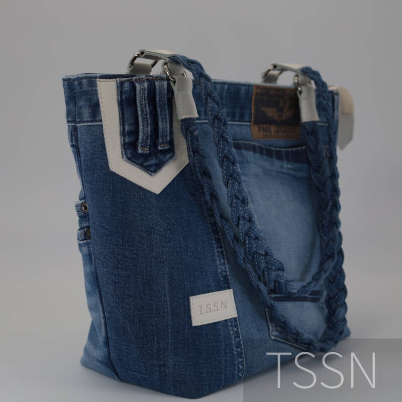 Zijaanzicht van denim herinneringstas model Eva 2 met gevlochten schouderbanden.