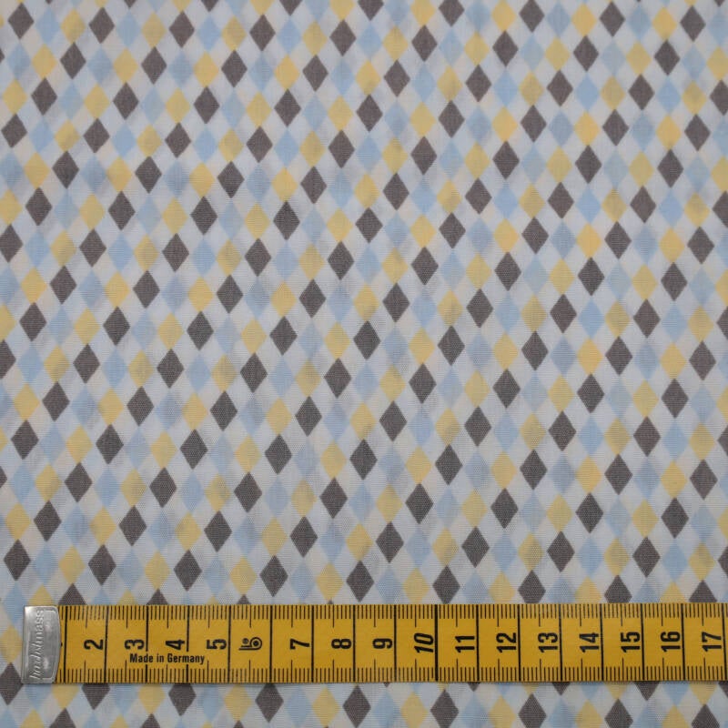 witte ondergrond met wybertjes in geel, lichtblauw en grijs