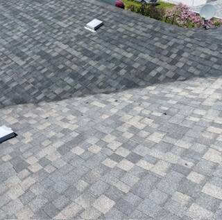 Asphalt shingles during NuRoof system application showing visible contrast between untreated and treated areas in Winnipeg