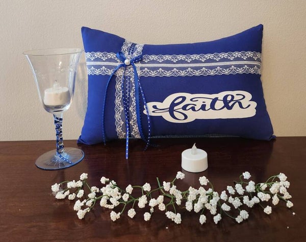 Faith Pillow with a decorative blue tint glassware