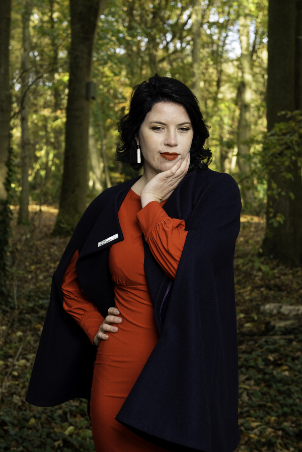 Art Historian Tascha Sciarone in her favourite red dress (her graduation dress) in the forest. Photo Benjamin de Groot.