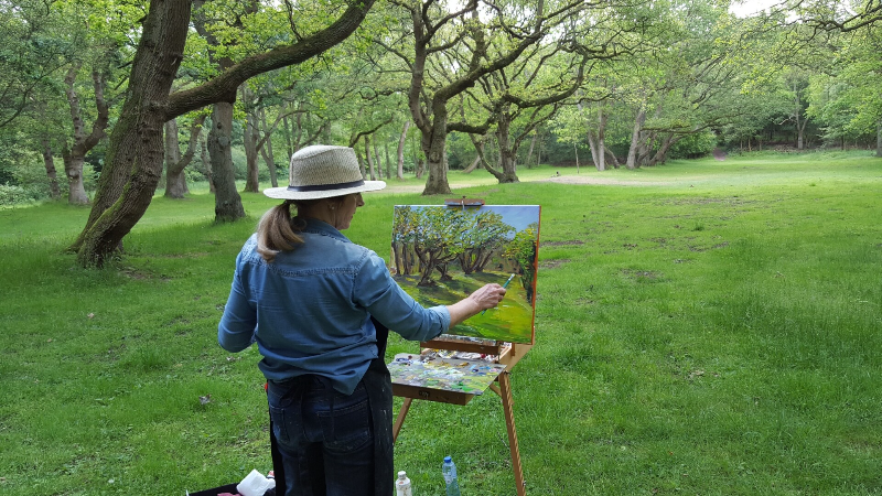 Jeanette Olyhoek painting a Dutch Landscape in the forest.