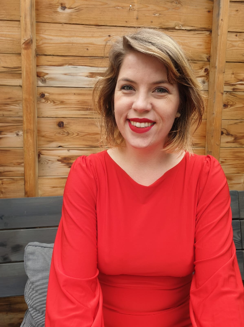 Smiling Art Historian Tascha Sciarone in a red dress