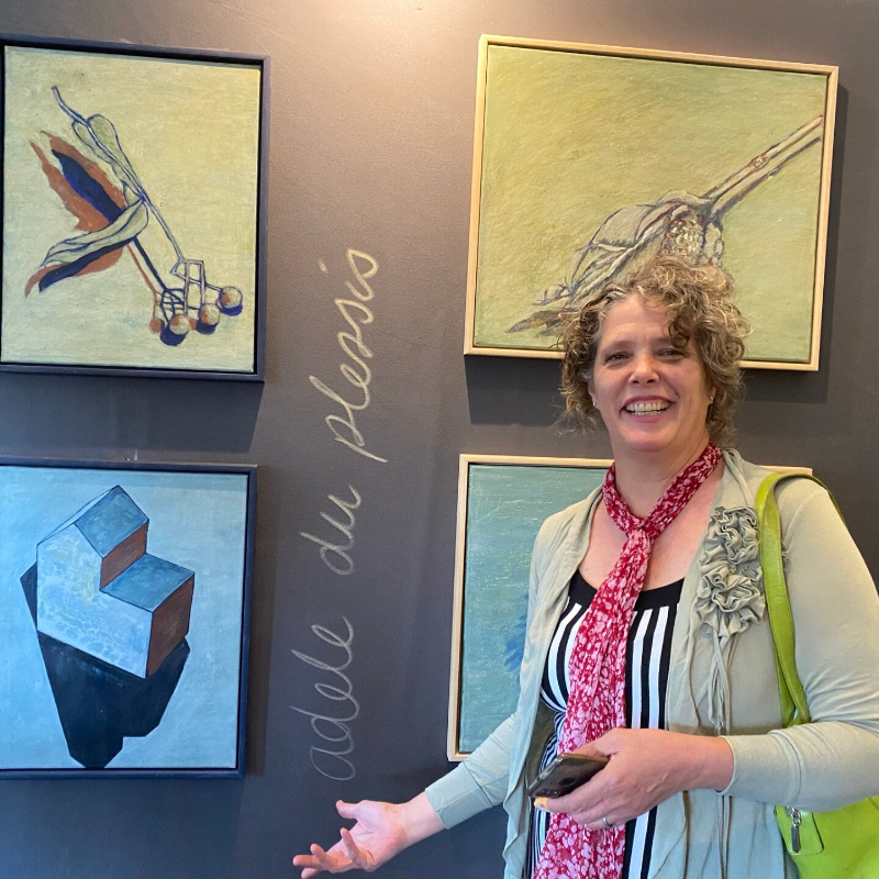 Artist Adéle du Plessis in front of her egg tempera pieces from her Drawn at Home series.