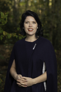 Art Historian Tascha Sciarone in a blue cloak in a forest in the Fall of 2020. Photo by Benjamin de Groot.