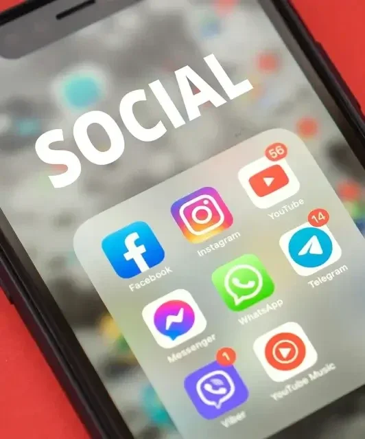 Smartphone screen with social media app icons including Facebook, Instagram, YouTube, WhatsApp, Twitter and Telegram, with word social overlaid