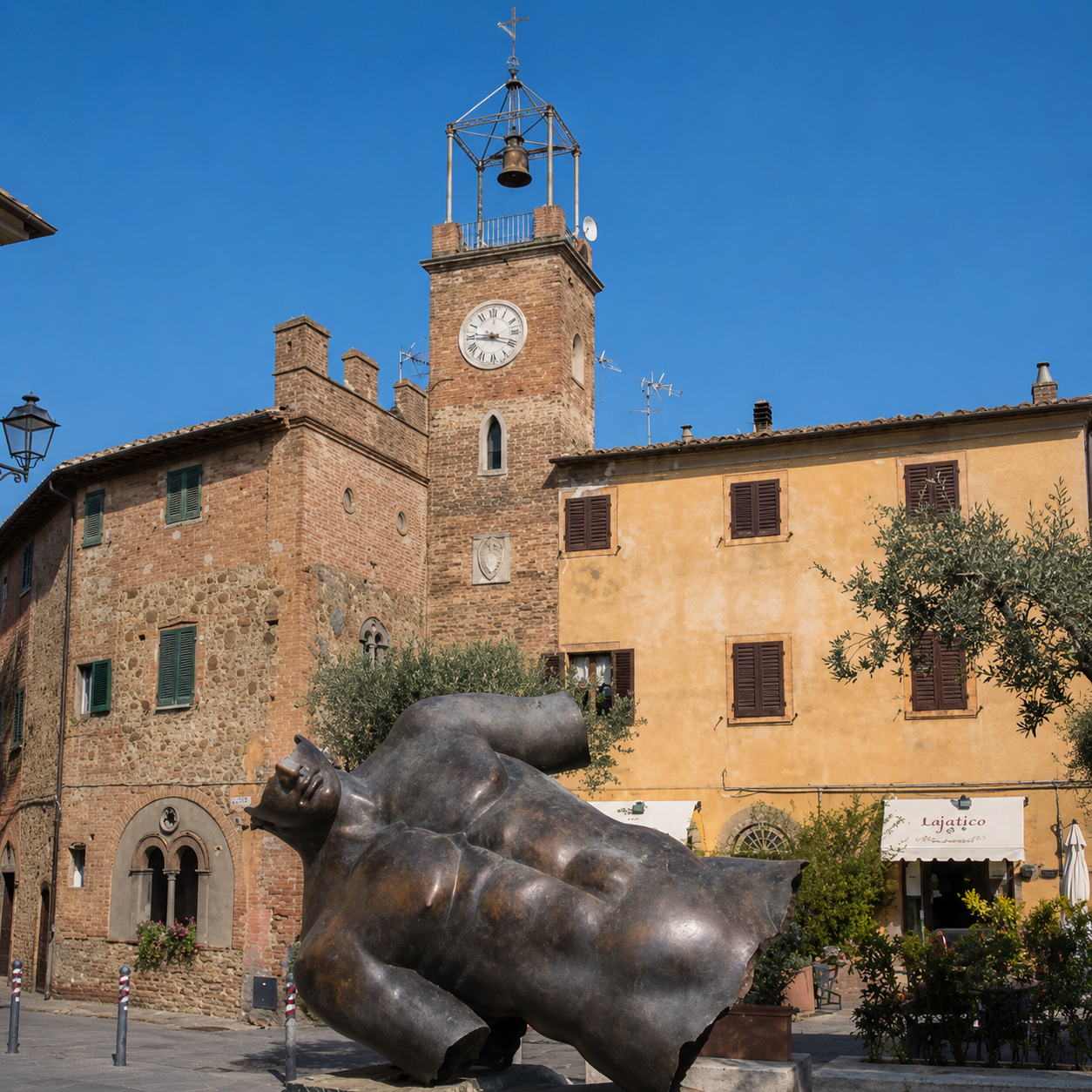 Piazza Vittorio Veneto in Lajatico featuring the 2025 artwork and the Castello con Torre dell'Orologio.