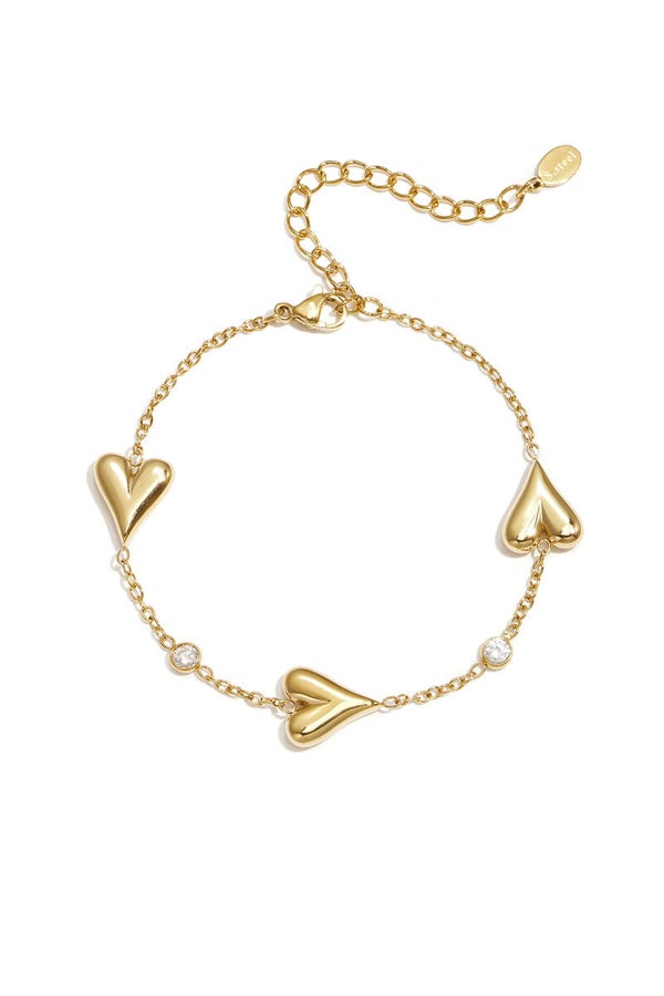 Drie massieve harten en steentjes armband Goud