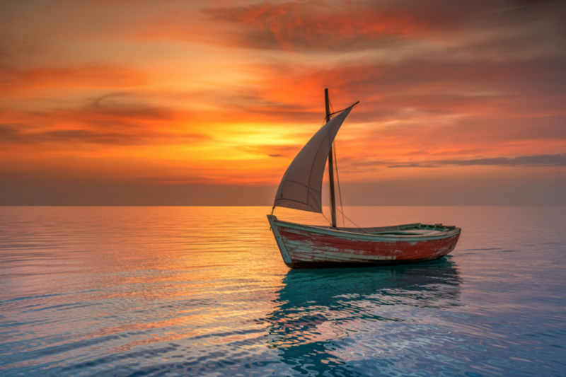 Kleines Segelboot auf ruhigem Wasser bei Sonnenuntergang – symbolisches Bild für Loslassen, Veränderung und den eigenen inneren Weg.