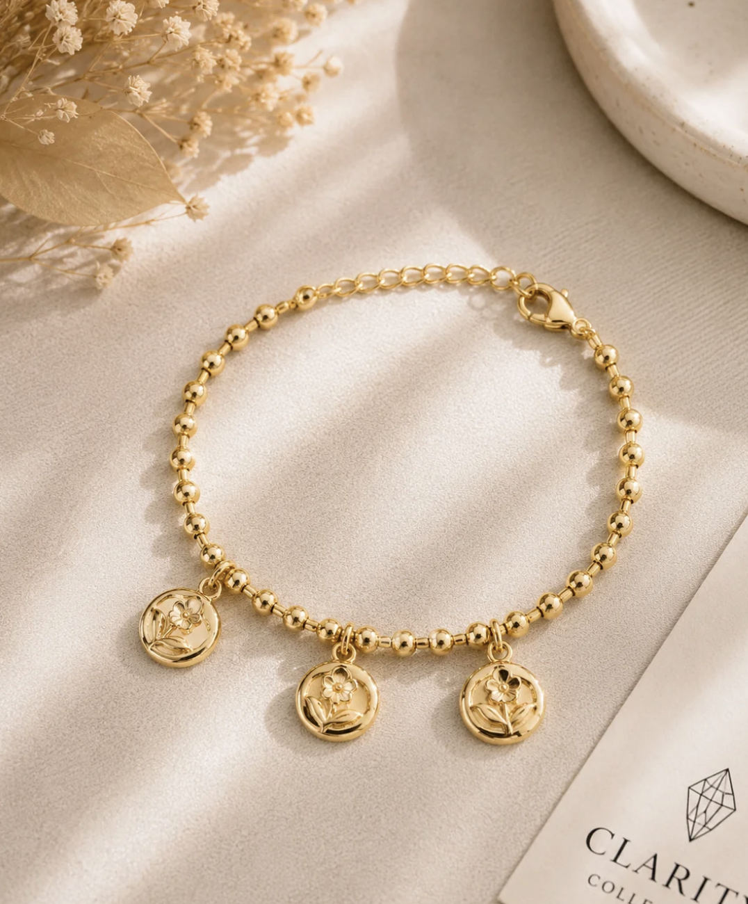 Bracelet doré médaillons fleurs