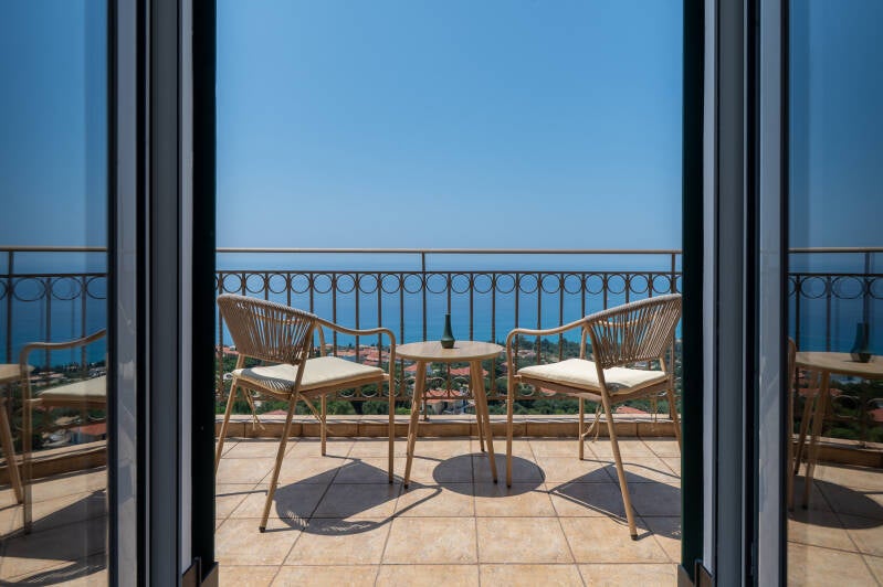 Balcony with outdoor seating and sea view from a luxury villa in Vlachata, Kefalonia, Greece.