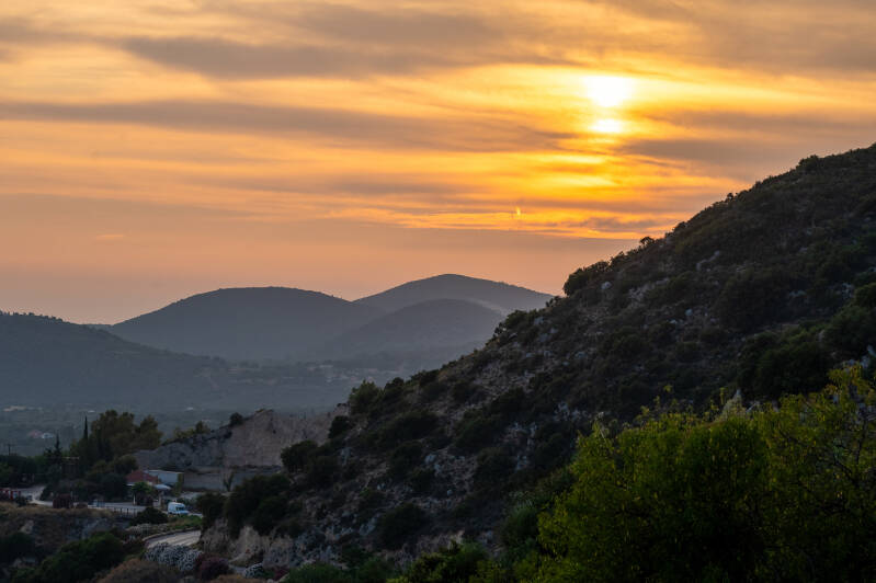 Golden hour sunset over rolling hills and sea in Vlachata, Kefalonia, Greece