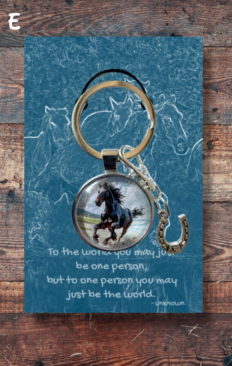 Black running horse with silver horseshoe charm on blue card
