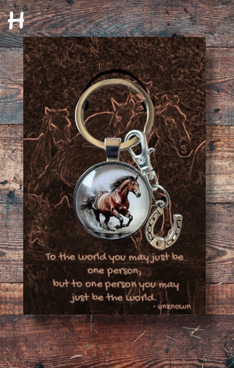Bay running horse with silver horseshoe charm, brown card