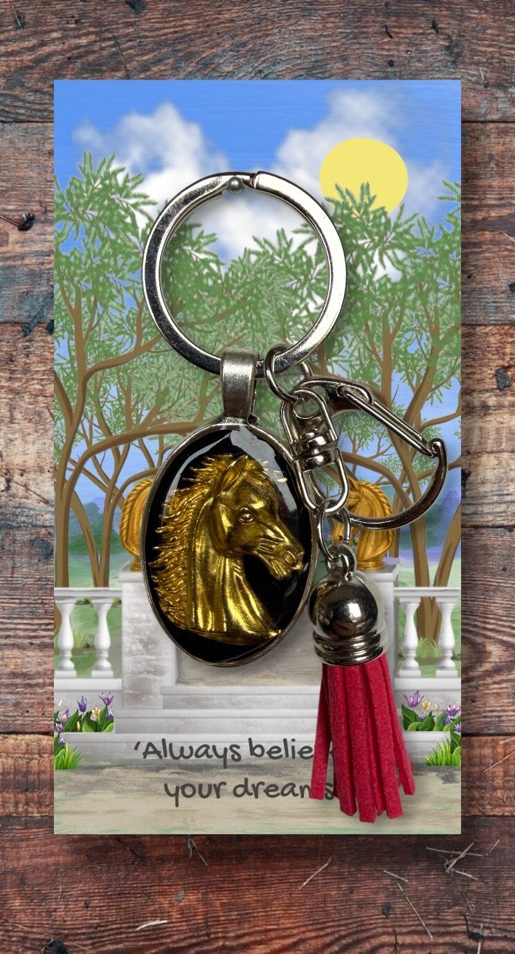 Golden horse head on silver key chain with clip and tassel
