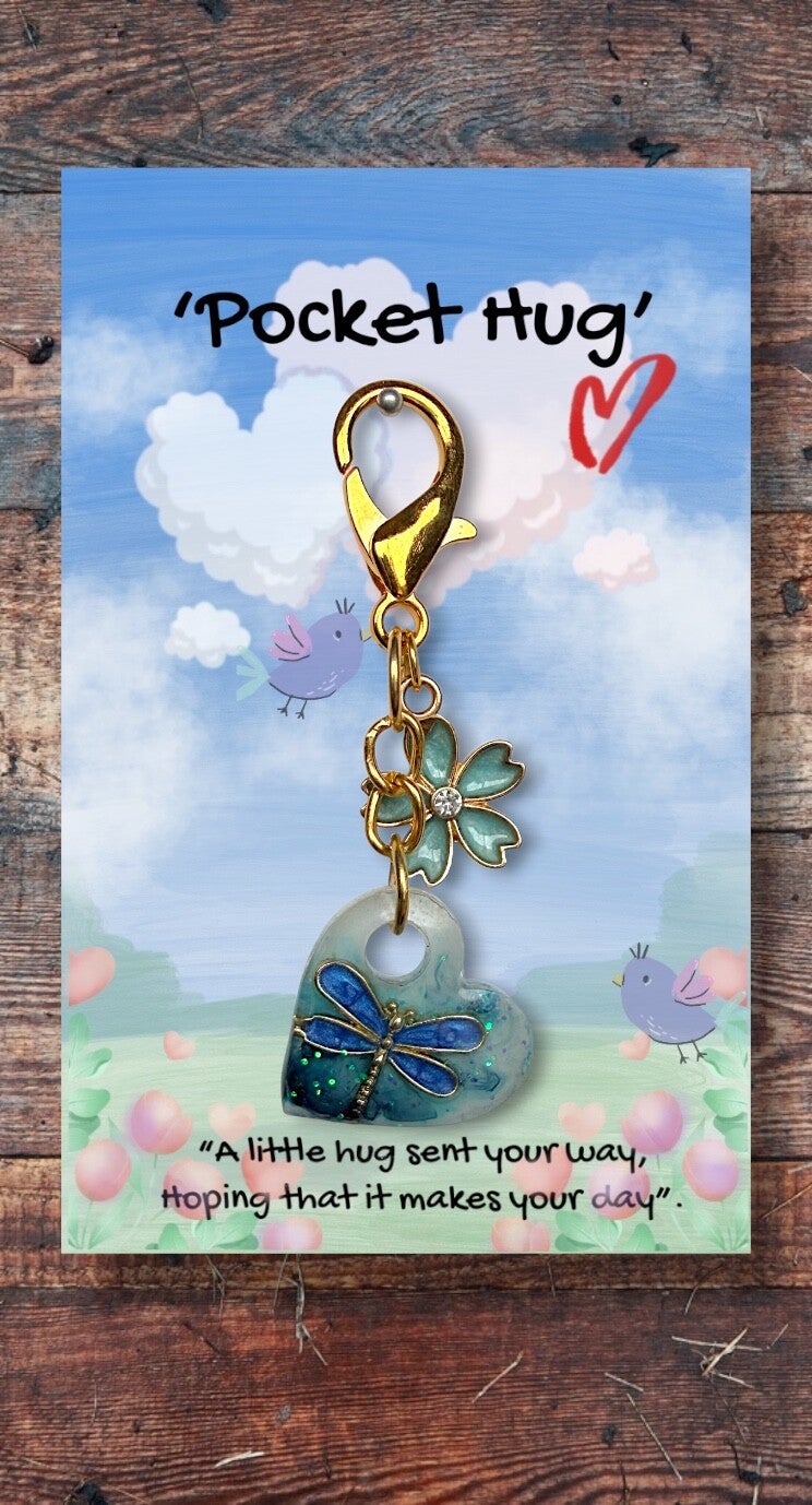 Beautiful little dragonfly in a heart, with a blue flower