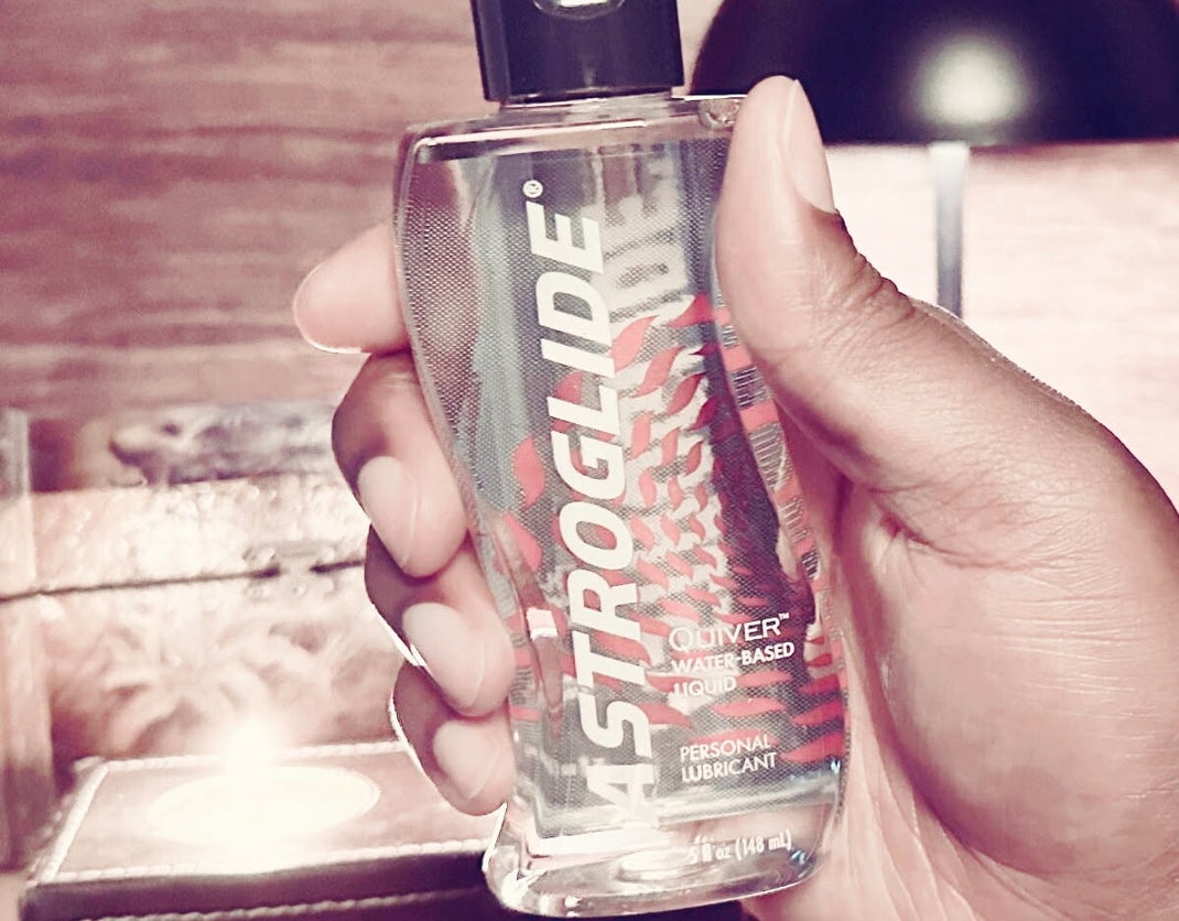 Black man's hand holding anal sex lubrication.