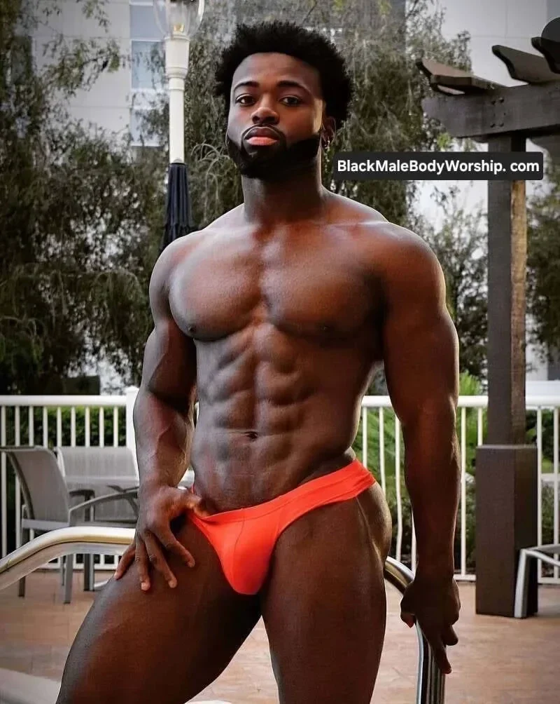 Powerful image of a shirtless Black man showing defined abs and chest, embodying masculine energy, self-mastery, and divine Black male strength.