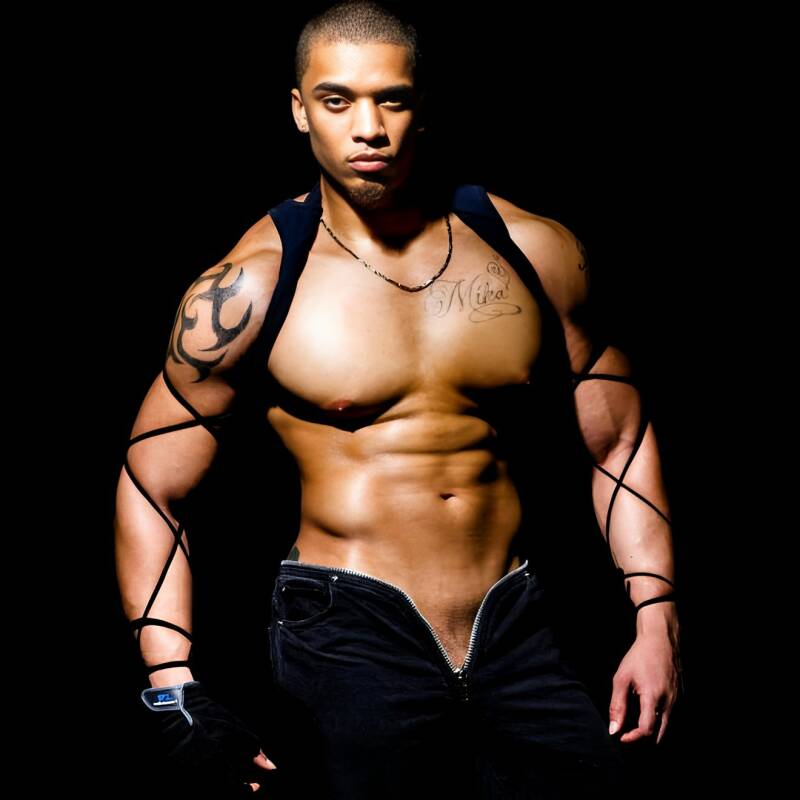 Artistic portrait of a tattooed, muscular male model wearing a harness and unzipped jeans against a black background. Dominant alpha partner, body worship, and fashion photography.