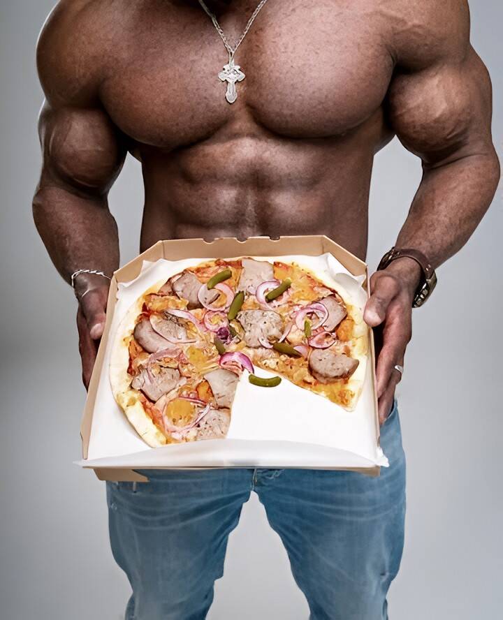 "Shirtless muscular Black man showing chest, abs, and arms, extending a pizza toward the camera representing a man choosing food over sex."