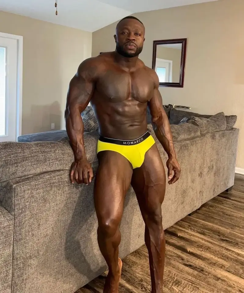 Buff man models yellow underwear in front of camera exuding good energy and breaking stigmas for men with body insecurities 