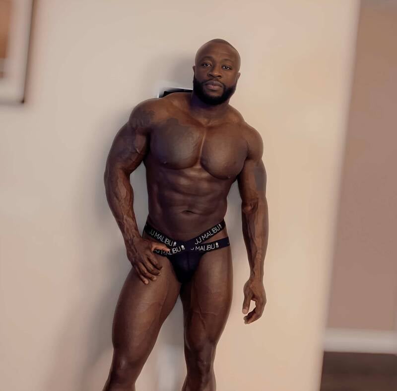 muscular Black man modeling thong underwear and chisled body in honor of positive affirmations and self-awareness to stay motivated to workout