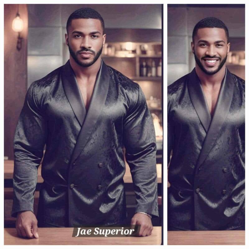 Blackmalebodyworship.com Owner Jae Superior, handsome Black man smiling, wearing a stylish black silk smoking jacket.