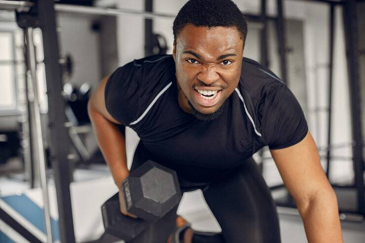 Focused Black man building strength and confidence through physical exercise for mental health and fulfillment