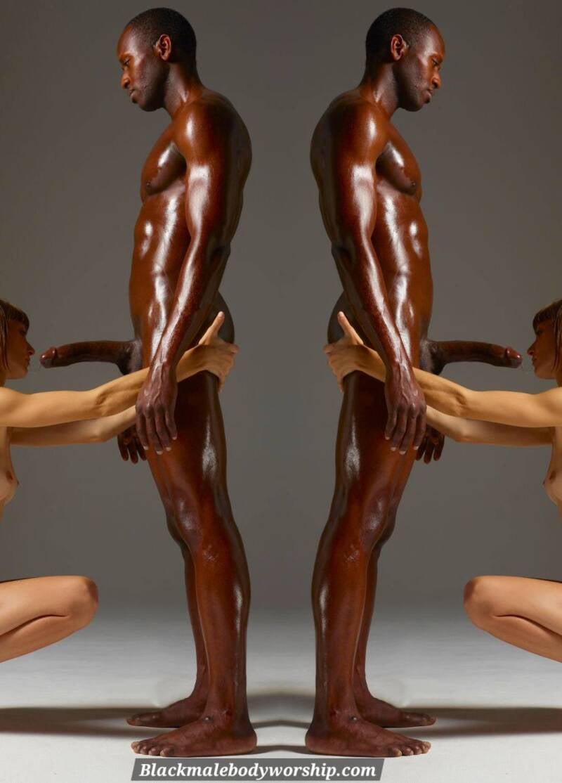 "Black Dom standing tall as submissive woman kneels in cock worship, power dynamic on full display."