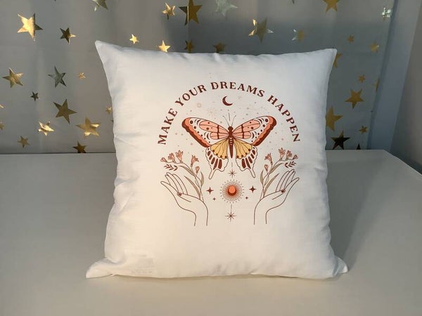 Pillow printed with “Make Your Dreams Happen”