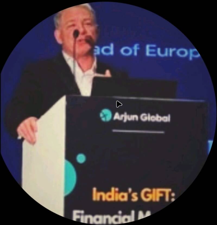 me presenting in India on stage at gift city