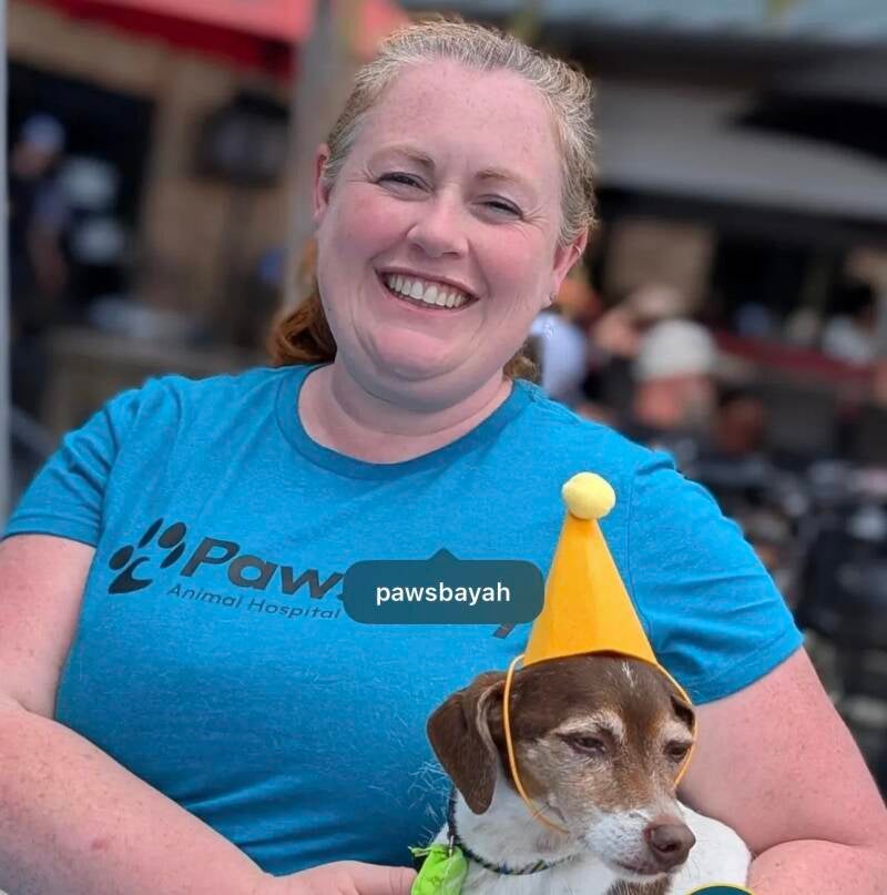 Dr. Highbrown at an Oldsmar / Westchase brewery event with her dog Rye wearing a party hat.